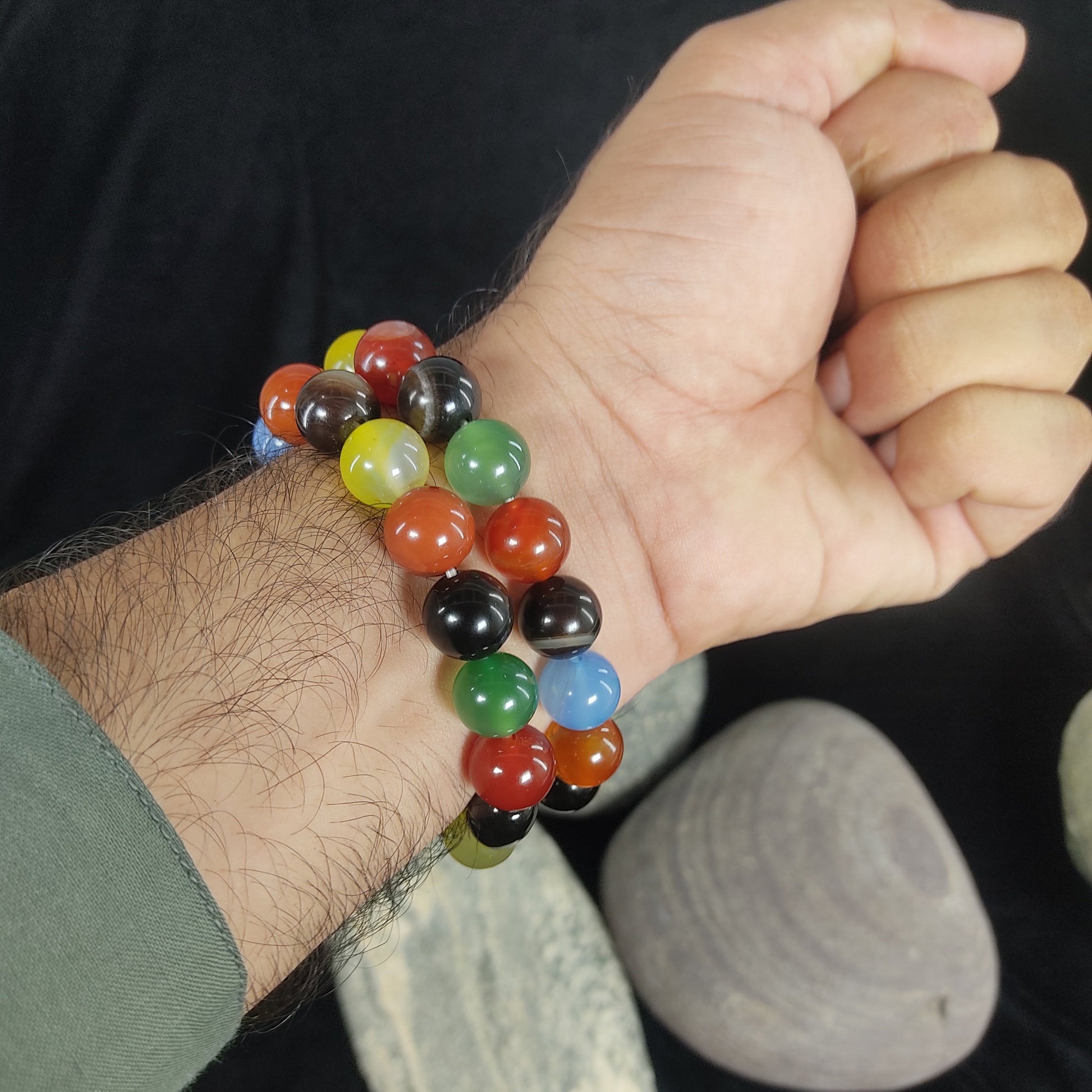 Multicolored beaded bracelet on a wrist with a blurred natural background